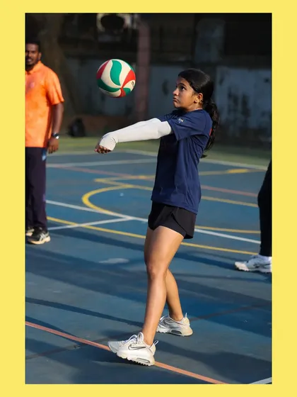 This young athlete demonstrates a perfect platform for an underarm pass. Her dedication during practice is clear to see.