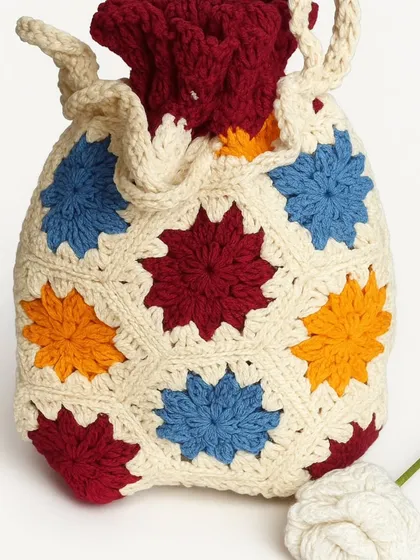 This vibrant crochet potli bag is a burst of color. It's crafted from soft, fine cotton yarn and is fully lined with cotton fabric, making it both beautiful and practical.