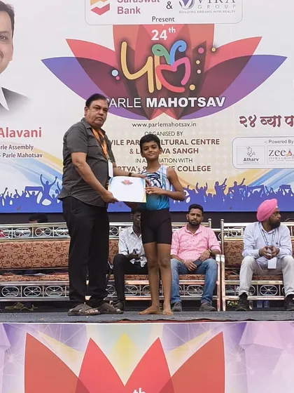 Veer Ugle, our gold medalist in the 7 to 9 boys' category, proudly accepts his certificate and medal. It is inspiring to see such dedication and skill at a young age.
