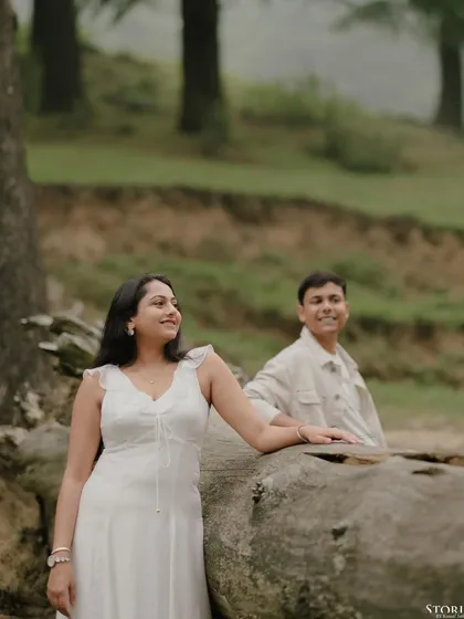 A beautiful, naturally lit portrait in the woods of Mussoorie, with the groom slightly out of focus in the background, creating a sense of depth and story.