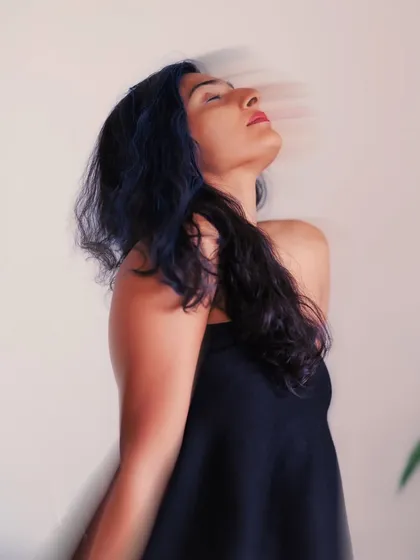 A purely expressive portrait using motion blur. The upward tilt of her head and closed eyes convey a feeling of ecstasy or release.