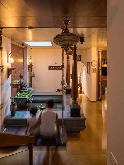 The heart of the 'Antara' residence is its central courtyard, complete with a traditional wooden swing and a tranquil water body, designed to be a space for connection and reflection.