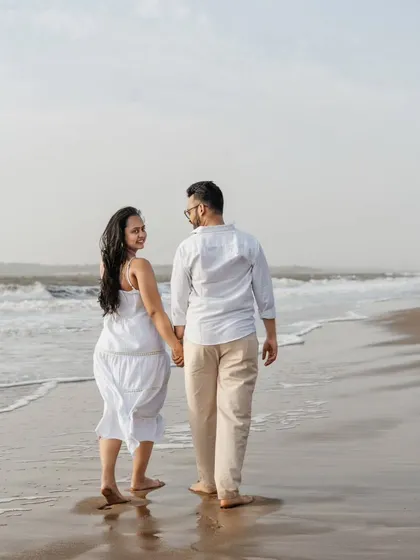 A candid shot of the couple taking a stroll along the shoreline. The way she looks back at him with a smile makes this such a sweet and spontaneous moment from their beach maternity session.