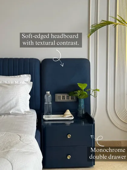 We are obsessed with the details. In this bedroom, a monochrome theme is elevated by textural contrast, featuring a soft-edged navy headboard and a matching double-drawer unit with custom hardware, proving that luxury lies in the small things.
