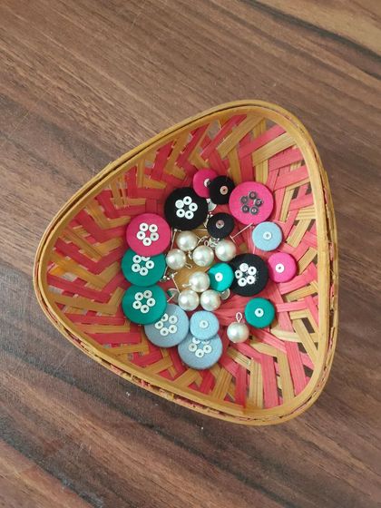 A glimpse of my work-in-progress materials. You can see colorful fabric components, beads, threads, and hand-painted pieces all waiting to be turned into beautiful jewelry.