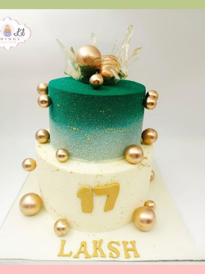 A stylish two-tiered cake for Laksh's 17th birthday, featuring a green ombre glitter effect and a cascade of gold spheres.