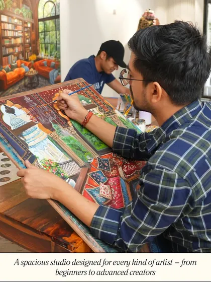 My studio is designed to be a spacious and inspiring environment for every kind of artist. This image shows students working on advanced paintings, demonstrating the professional setup available for serious creators.