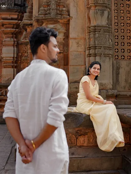 A playful and creative shot at the temple. This composition tells a story and adds a dynamic element to the pre-wedding album.