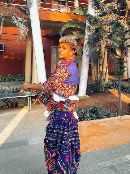 A stylish pose in a purple dhoti and embroidered Kedia. This outfit is a perfect blend of traditional craftsmanship and modern style.