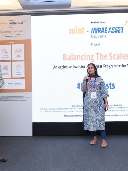 Inviting audience members to share their thoughts at the 'Balancing The Scales' program. My goal is to make every attendee feel seen and heard.