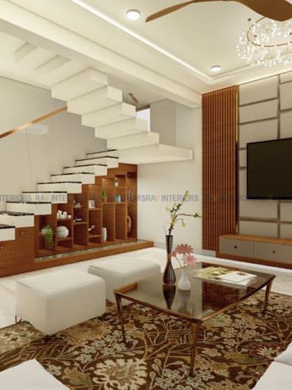 A view of a living room showcasing the TV unit and the adjacent staircase. The design uses a consistent wood and white theme to create a cohesive and elegant space.