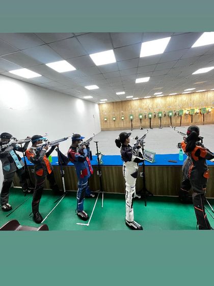 A different angle of our national rifle shooters during a group training session, showcasing their professional gear and synchronized focus.