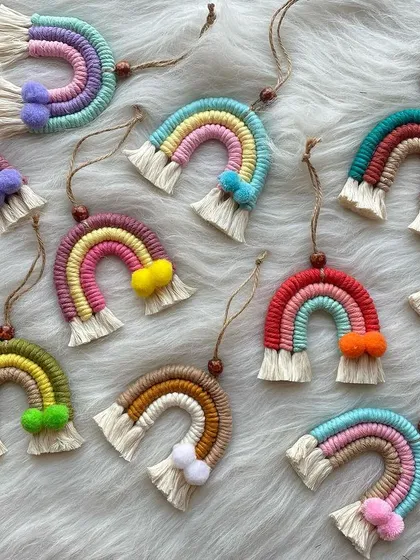 A cheerful collection of my mini macrame rainbow charms. These versatile pieces can be used as car dashboard ornaments, bag charms, or even small wall hangings. Each one is made with colorful cords and features a tiny pom-pom accent.