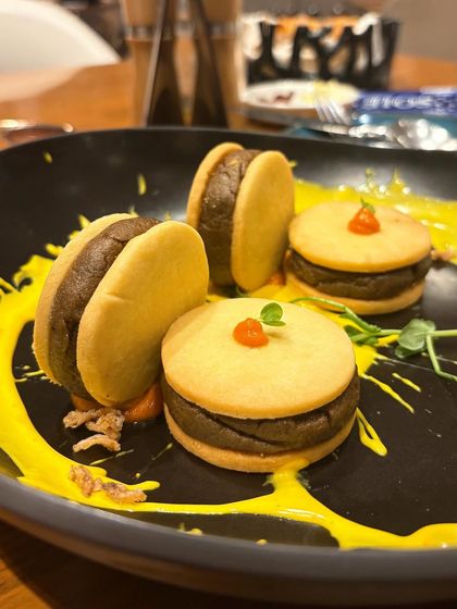 A close up of the Gucchi Galouti at MKT. The unique presentation in savory biscuits is the focus here, highlighting the creativity of the chef.