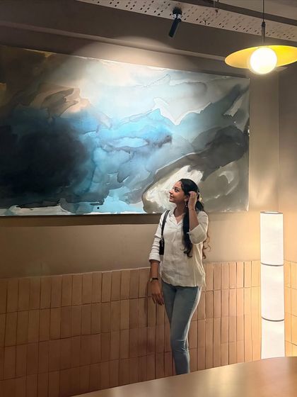 Another shot of me with my large-scale fluid art painting in Lucknow. It's so rewarding to see the artwork in its final home, adding to the atmosphere of the space.