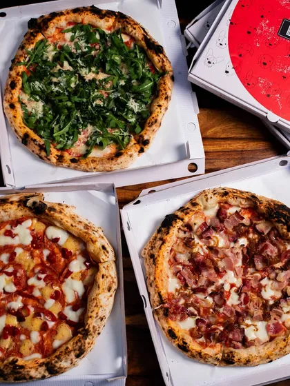 A trio of our pizzas, boxed up and ready for a pizza party at home. We've got our Parma Ham, a classic cheese, and another favourite.