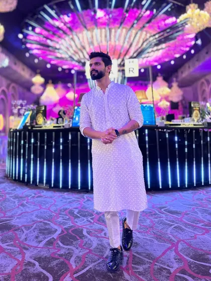 Keeping it calm and sparkling in a classic white Chikankari kurta. A timeless look for any wedding event.