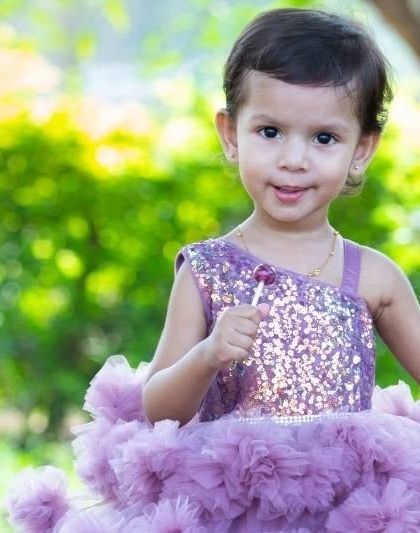 A close up portrait that shows off her sweet expression and sparkling eyes. Even with a simple, natural background, a child's face can tell the most wonderful story.