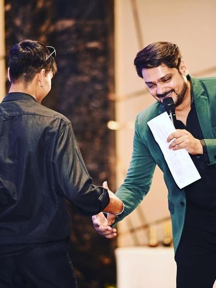 Welcoming a winner on stage during an awards ceremony. I ensure a smooth transition between segments, keeping the energy high throughout the night.