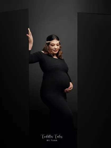 Motherhood is not just soft and gentle; it is fierce, resilient, and powerful. This moody, artistic portrait in classic black is a tribute to the inner strength that defines this journey. It’s a celebration of the woman you are and the mother you are becoming.