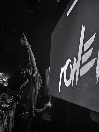 A dramatic black and white shot from the side of the stage at Mikachi Club.