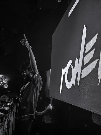 A dramatic black and white shot from the side of the stage at Mikachi Club.