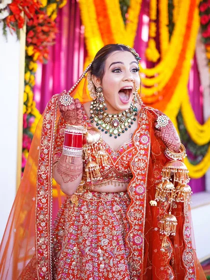 Capturing the bride's fun and bubbly personality is just as important as the poised shots. This candid photo of her joyful expression is infectious and real.