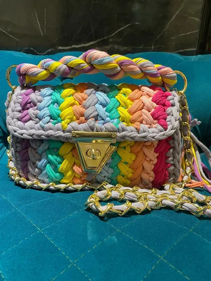 Another look at the rainbow marshmallow bag, showing off its vibrant colors against a solid background. Each color is carefully woven in to create this cheerful pattern.