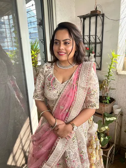 A candid shot of the bride-to-be by the window. The natural light highlights the flawless application and the soft, romantic feel of the makeup.