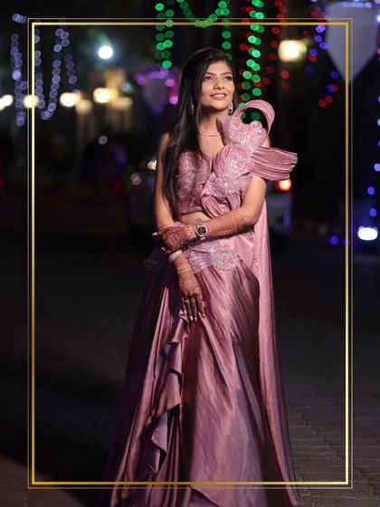 A full-length shot of the client in the stunning mauve gown against a backdrop of city lights. This is how you create an unforgettable look.