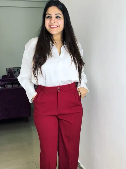 A simple and chic formal look with a classic white shirt and bold red trousers. This is a great example of how to add a pop of color to your workwear wardrobe.