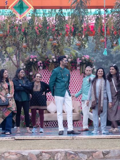 A candid shot of the family on stage, enjoying a light-hearted moment during the Mehendi ceremony I was hosting.