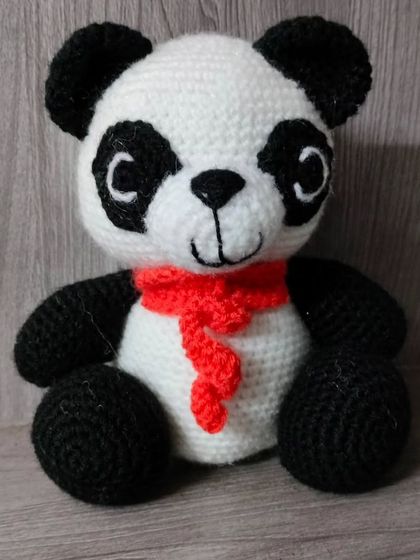 A handmade crochet panda with a little red scarf. He is very soft and cuddly, perfect for hugs.