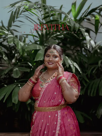 A portrait of a bride in a beautiful pink saree, capturing her radiant smile and elegant pose.