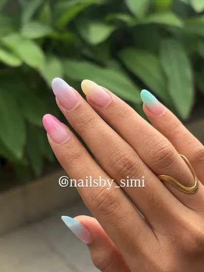 A full view of the pastel ombré nails, showing how each nail has a different color gradient.