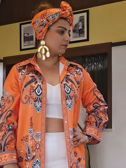 Another shot of my festival look. The orange printed shirt and turban are paired with our bold, geometric gold earrings for a standout style.
