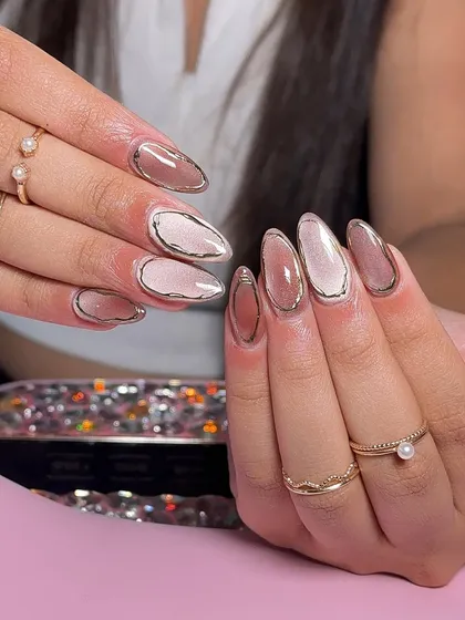 A beautiful multi-toned cat-eye set, with each nail showing a different shade of nude and pink, outlined with a fine silver chrome line.
