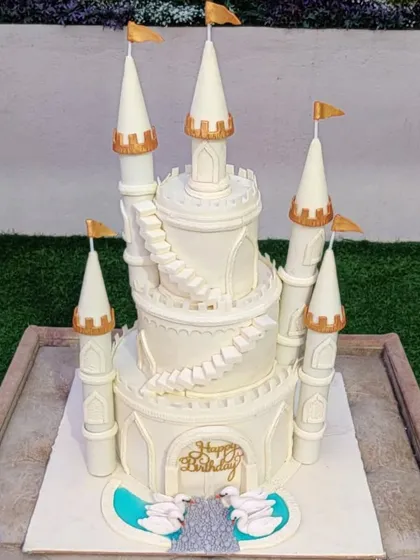 For a true fairytale celebration, I create grand, multi-tiered castle cakes like this one. The intricate details, from the towering turrets to the delicate swans, are all handcrafted to make your princess's dream come true.