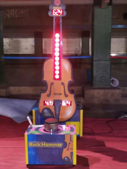 Test your strength with the classic 'Rock Hammer' game. This high-striker machine lights up to show the score, bringing out the competitive spirit in everyone.