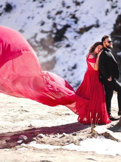 A stunning contrast of the hot pink gown against a snowy landscape. The color looks incredibly vibrant and makes for a unique and memorable pre-wedding photo.