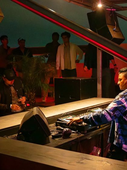 From the console at a rooftop party. There's a special magic to playing music under the open sky as the evening sets in.