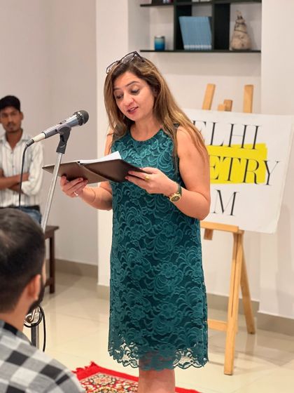 A poet reading from her journal, sharing a personal piece with the audience. We encourage originality and heartfelt expression above all else.