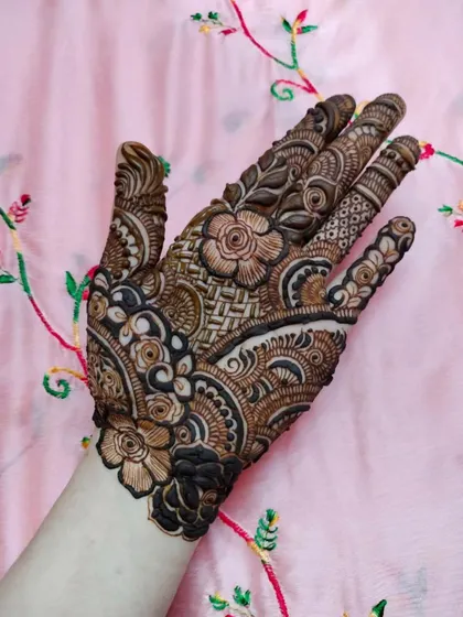 A lovely design for the back of the hand, combining floral elements with geometric fillers for a balanced and beautiful look.
