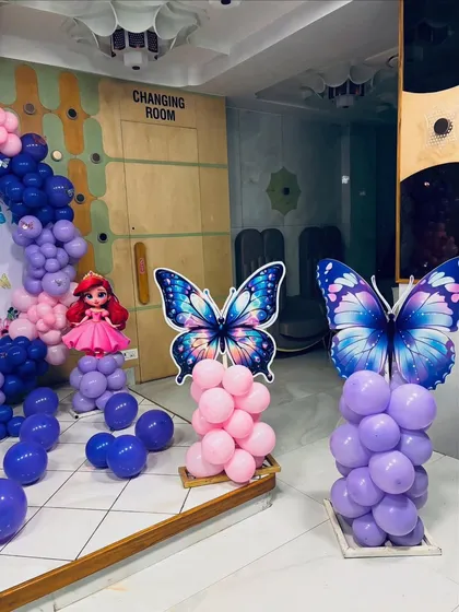 Large butterfly cutouts on balloon pillars add to the enchanting atmosphere of this butterfly-themed party.