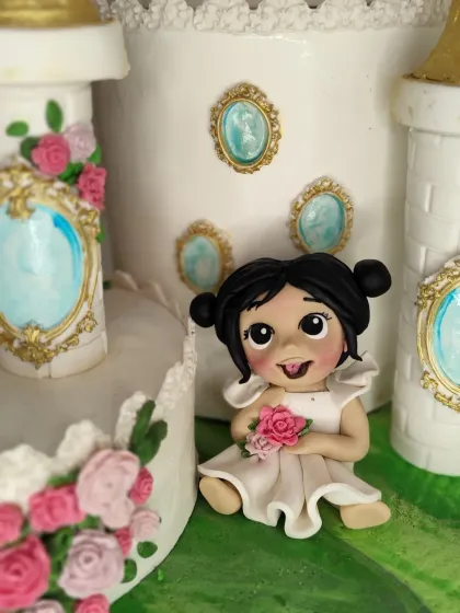 A close-up of the sweet princess figurine I made for Falyn's castle cake. I love her cheeky expression and the tiny bouquet of roses she's holding.