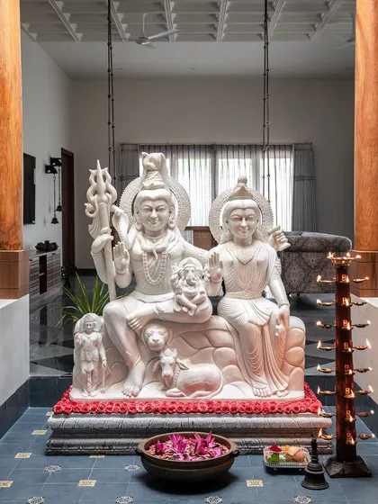 The heart of our Prangan project is this courtyard, featuring a magnificent 1500kg marble statue of Lord Shiva and his family, sourced from Varanasi. Flanked by massive teak pillars, this space is the spiritual and aesthetic anchor of the home, embodying serenity and devotion.