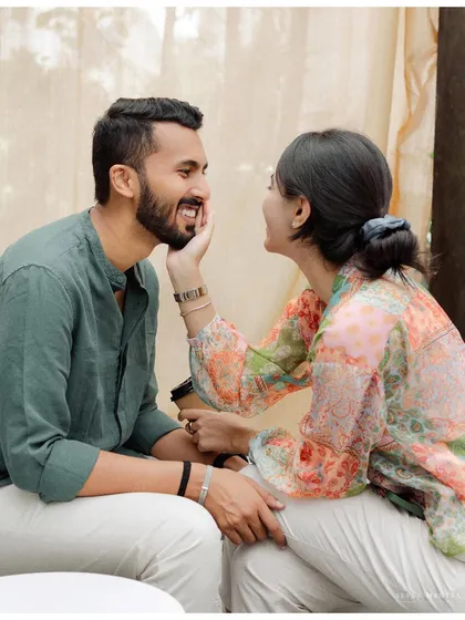 A gentle touch that brings a smile to his face. It's these small, affectionate gestures that we love to capture during our intimate pre-wedding sessions.