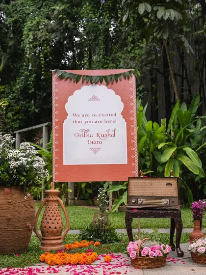 A wider view of the welcome area for the naming ceremony. The combination of the rustic sign, antique props, and fresh flowers created a warm and inviting entrance for guests.
