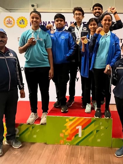 Our team celebrating on the podium after winning medals at the Nagaraj Rao shooting competition.