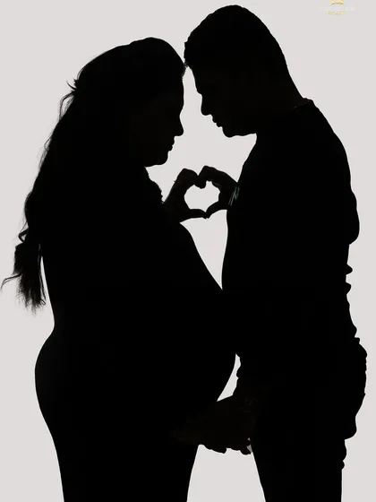 Sometimes, a silhouette tells the most powerful story. We use creative lighting in our studio to craft these artistic and romantic portraits that focus on the beautiful shape of the baby bump and the connection between partners.